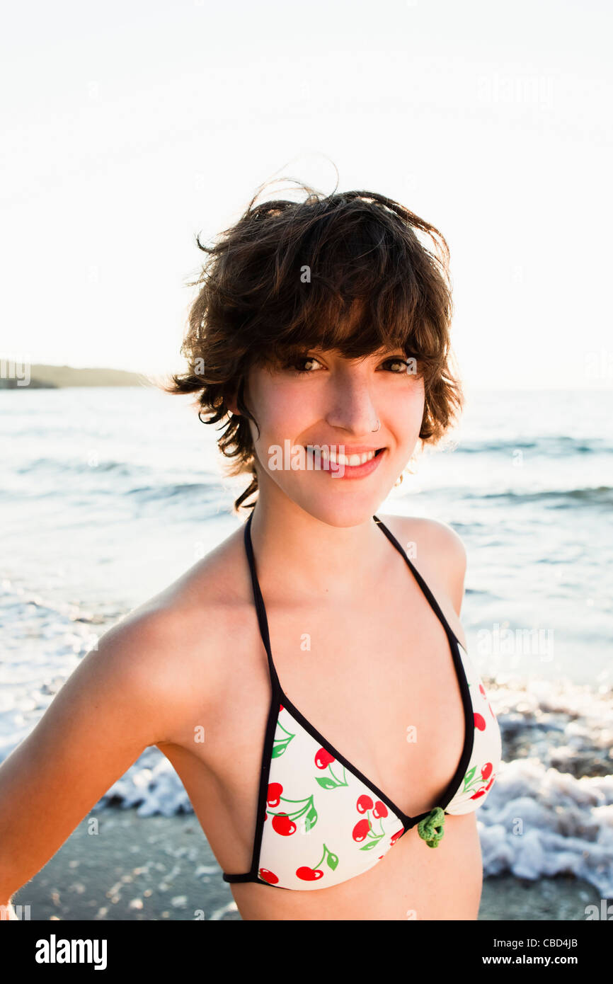 Woman smiling in bikini on beach Stock Photo
