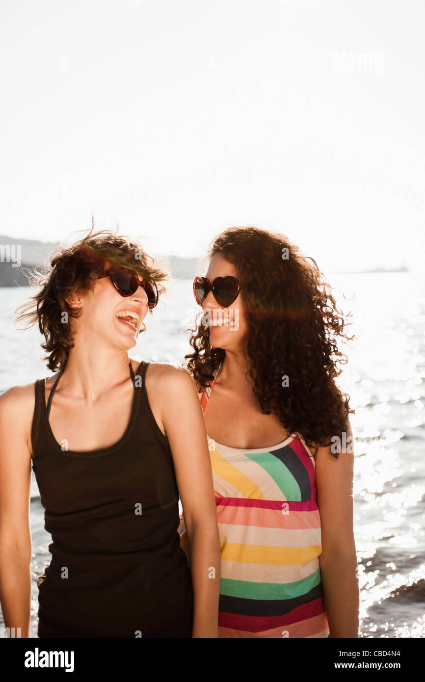 Laughing women in sunglasses on beach Stock Photo