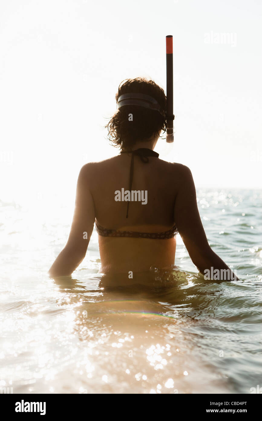 Woman wearing snorkel in water Stock Photo