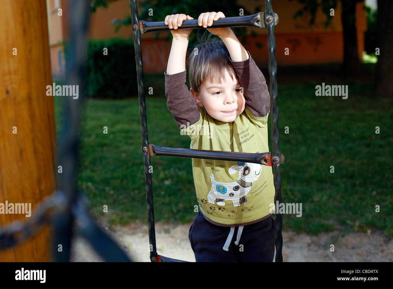 A boy is hanging on a rope ladder. (CTK Photobank / Josef Horazny) Model Released, MR Stock Photo