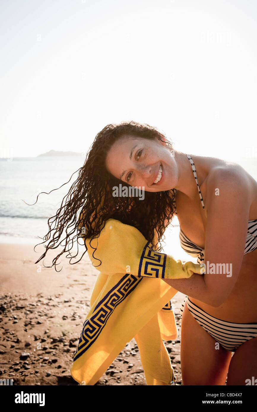 Woman drying her hair on beach Stock Photo