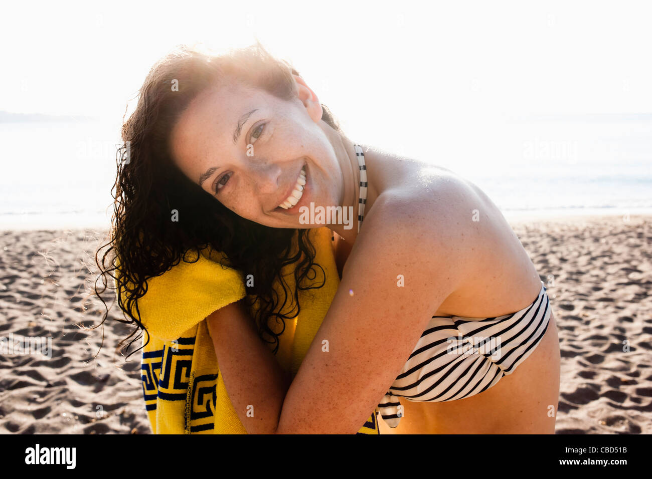 Woman drying her hair on beach Stock Photo