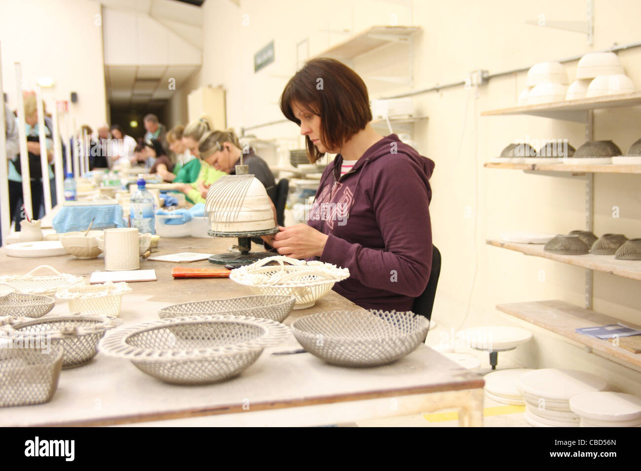 Lady making fine pottery at Belleek pottery in Northern Ireland Stock
