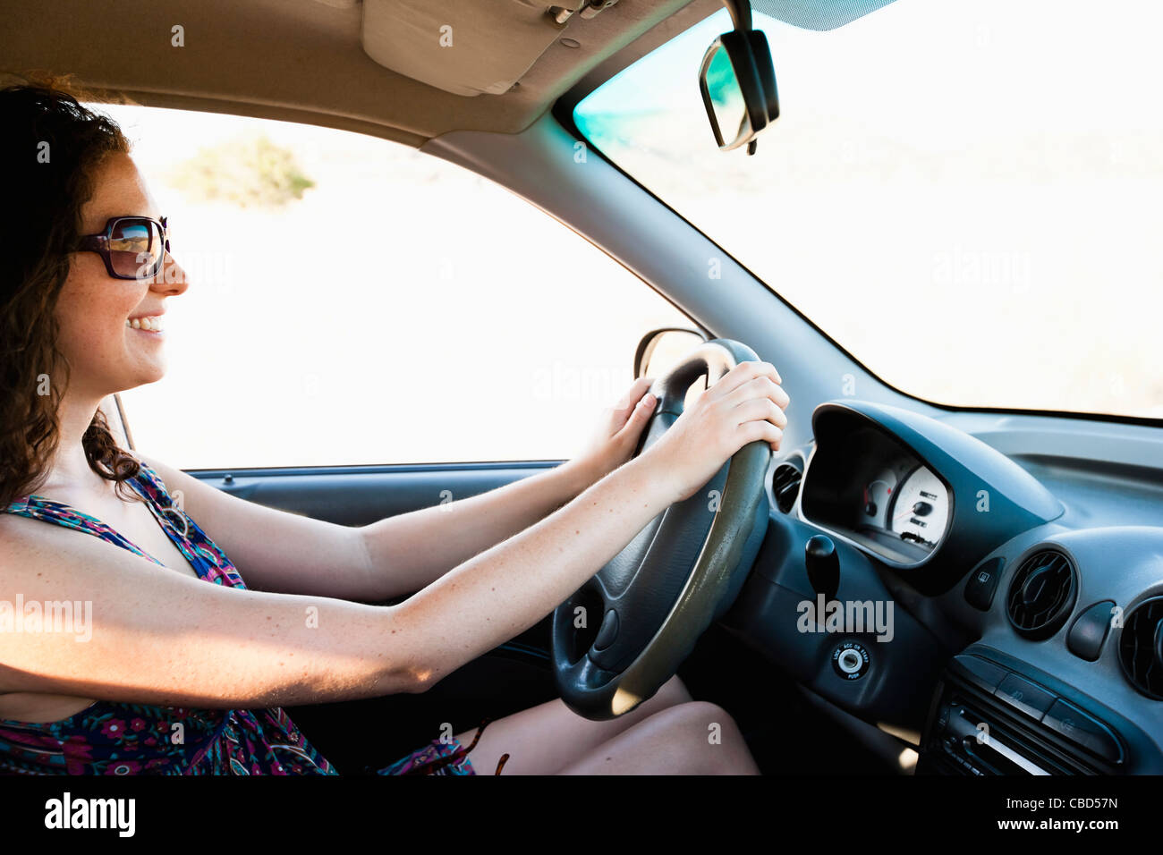 Smiling woman driving car Stock Photo