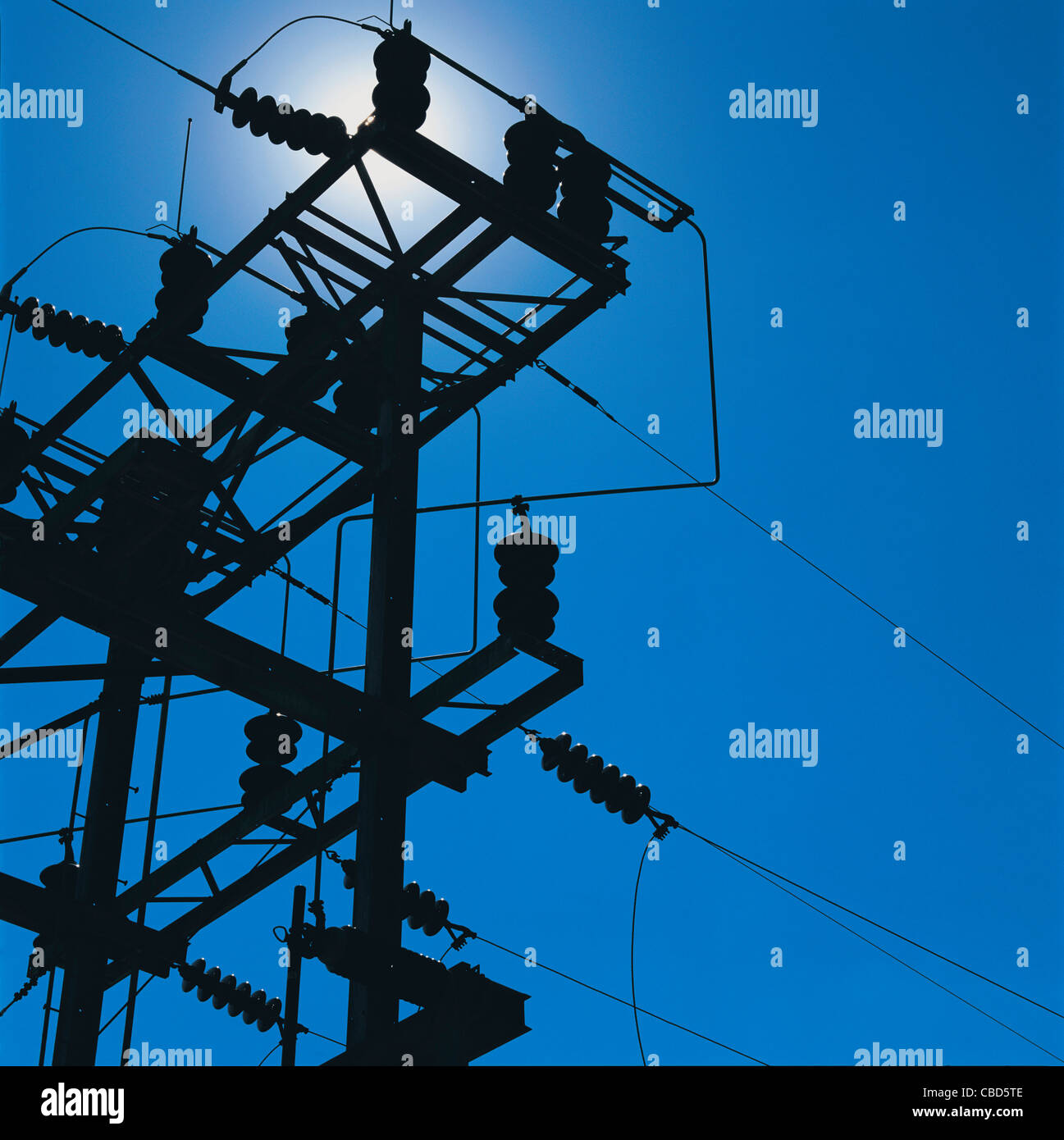 Power lines against blue sky Stock Photo - Alamy