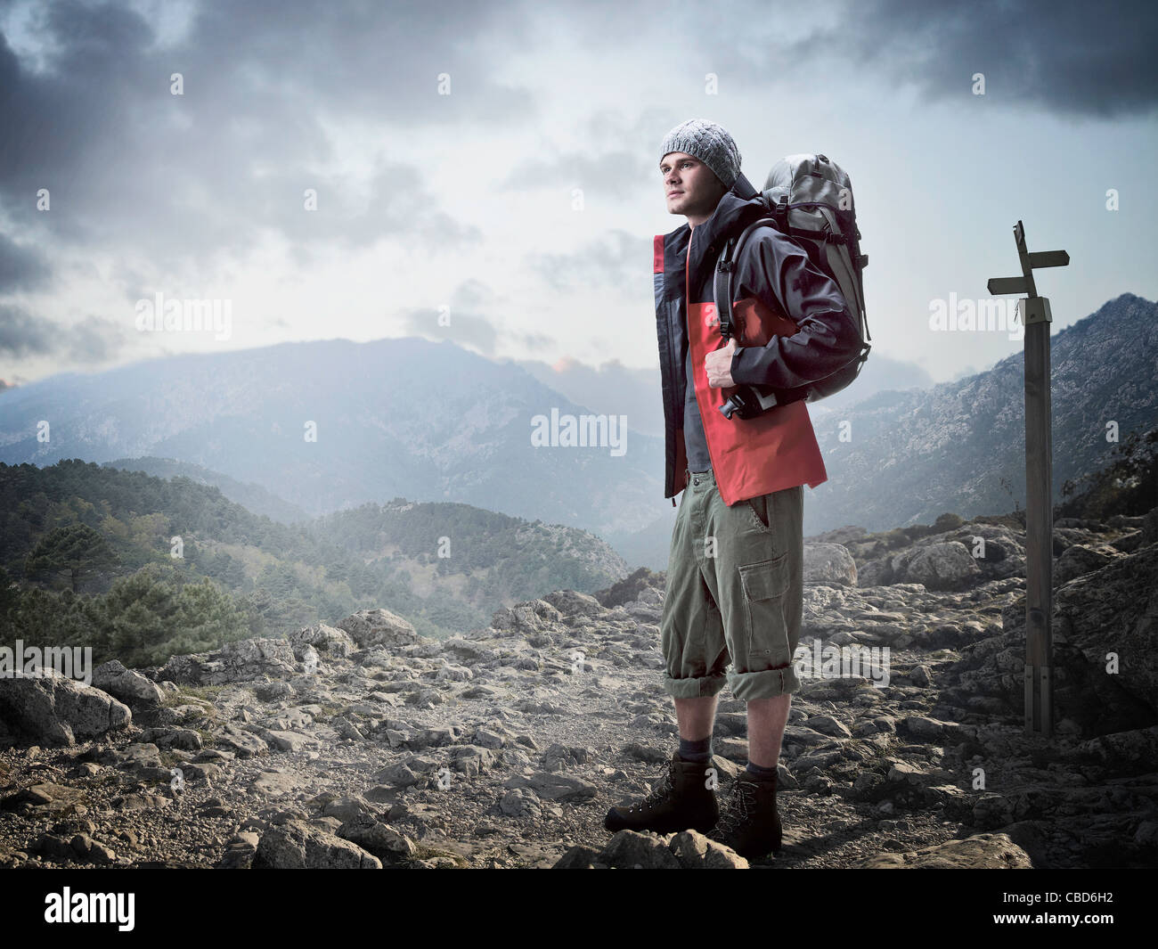 Hiker standing in rocky terrain Stock Photo