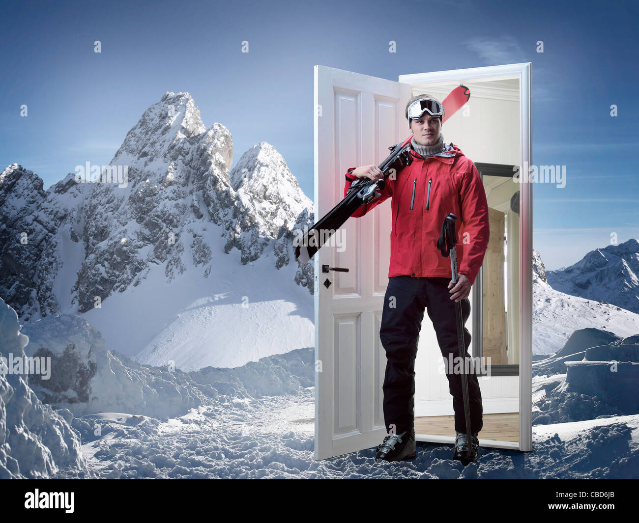 Skier emerging from door in mountains Stock Photo