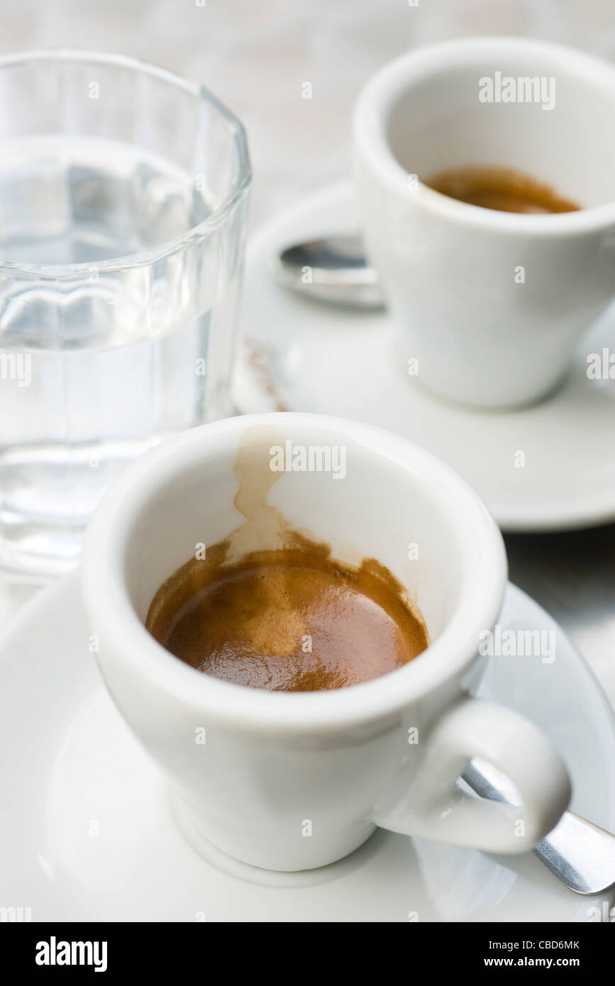Espresso cups and glass of water Stock Photo Alamy