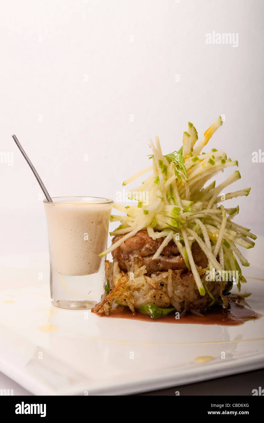 Sweetbreads topped with Granny Smith apple and port wine gravy Stock Photo