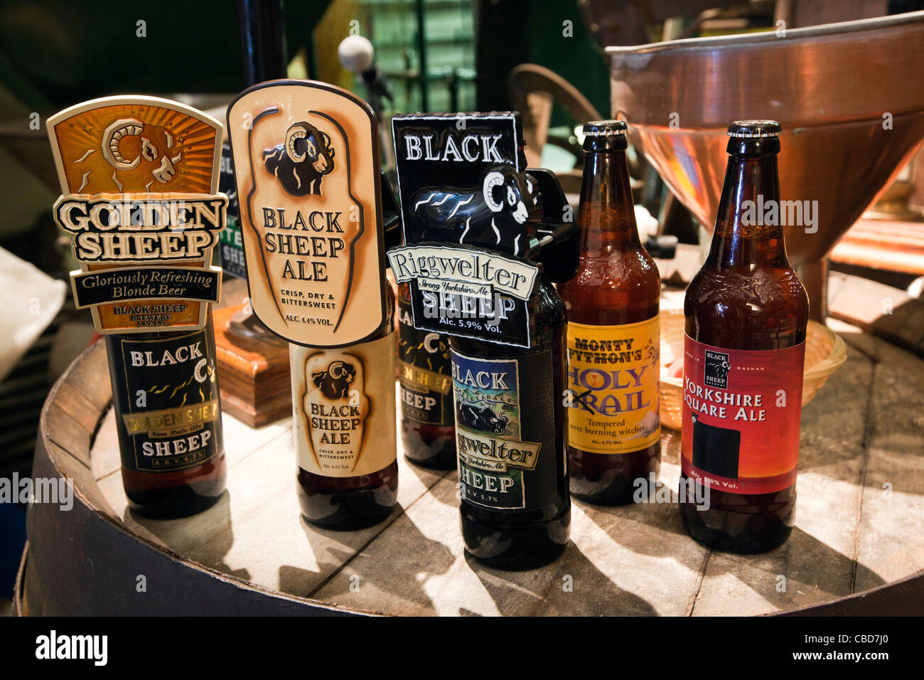 UK, England, Yorkshire, Masham, Black Sheep Brewery, bottled beers on end of old fashioned wooden beer barrel, Stock Photo
