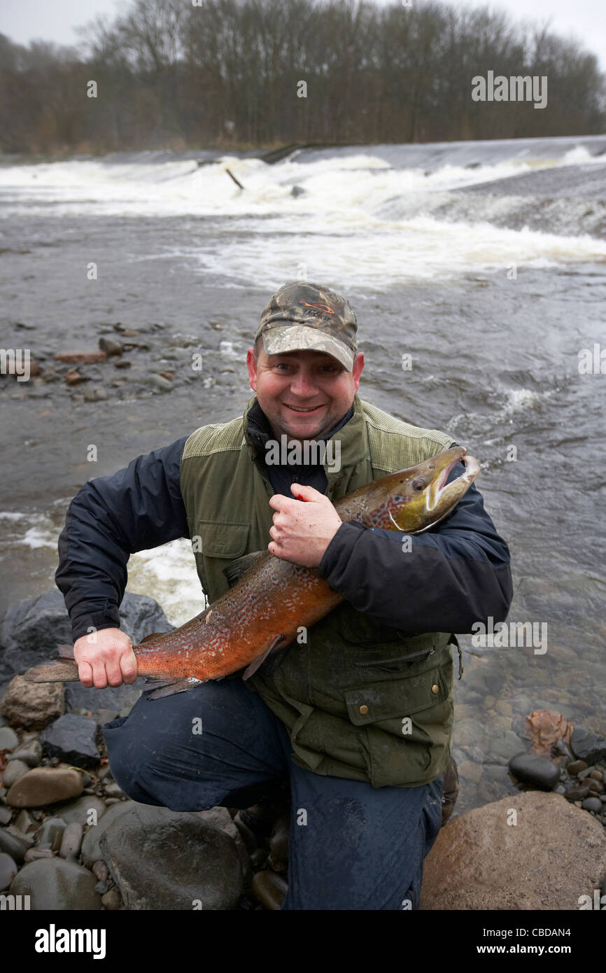 Angler with 15lb Salmon caught fishing the Ettrick water cauld, Philiphaugh, Selkirk, Scotland, UK Stock Photo