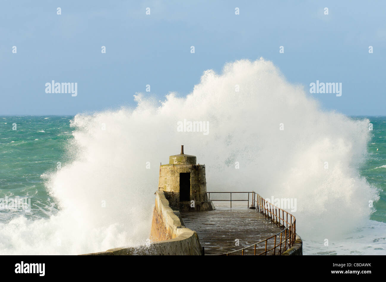 Portreath, on the North coast of Cornwall, between Newquay and St Ives showing the pier being hit by a large wave Stock Photo