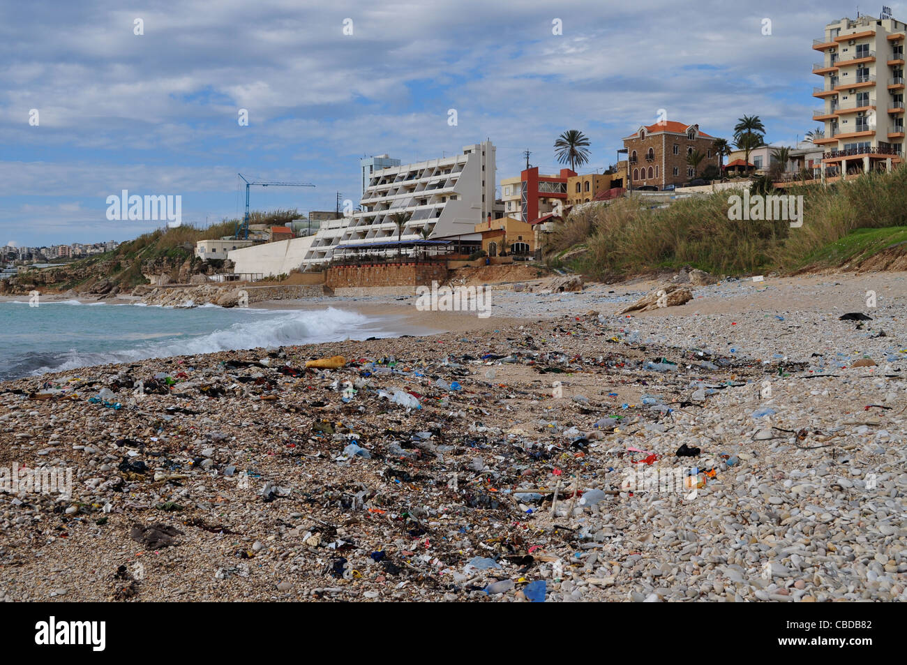 Litter strewn, pre open season beach at Jbeil aka Byblos where hundreds of tourists  will soon throng and swim. Stock Photo