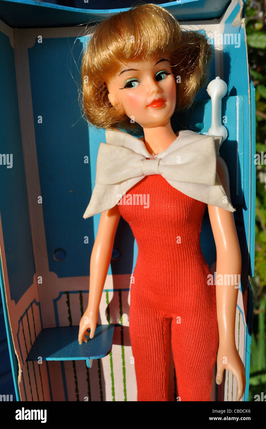 1965 vintage Grown Up Tammy doll by Ideal in original red catsuit with her phonebox packing. Tammy dolls were made 1962-1966 in Stock Photo