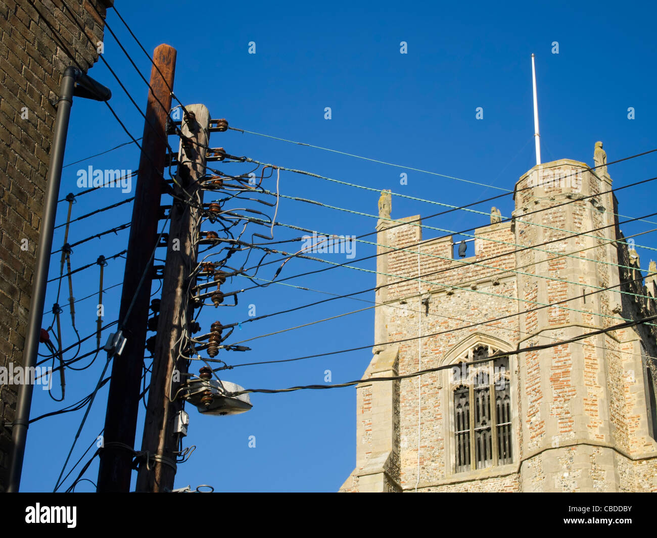 Multiple electrical cables running from a tall post, cutting across the