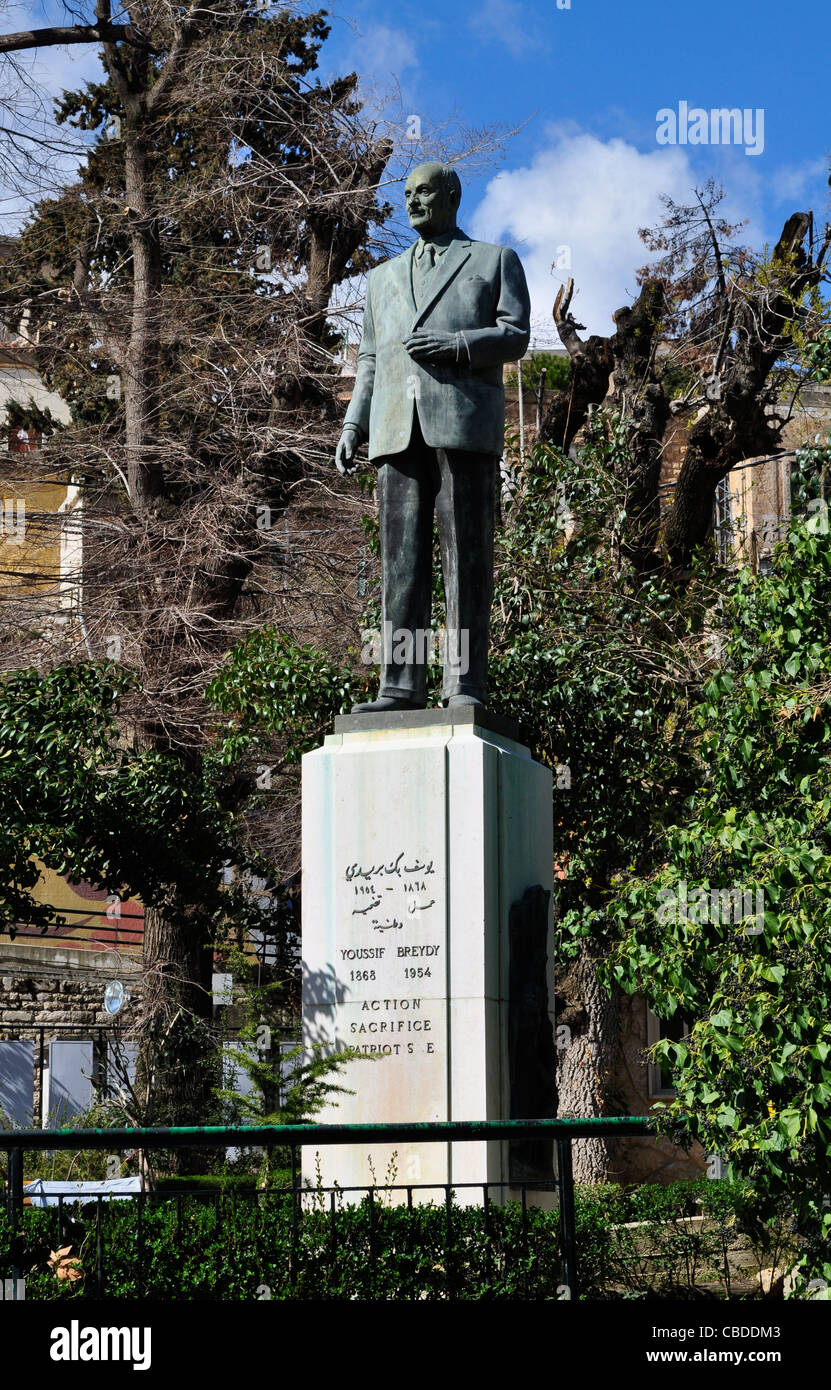 Statue commemorating Lebanese patriot Youssif Bpeyedy on the Birdawni river that runs through the town. Lebanon. Stock Photo