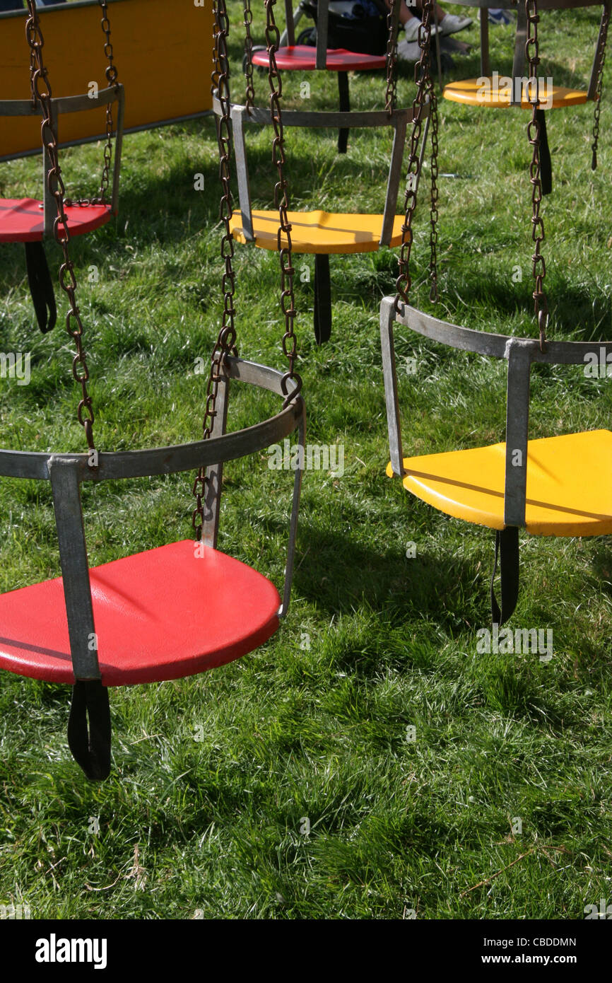 colourful swing seats on carousel type ride at fair ground Stock Photo