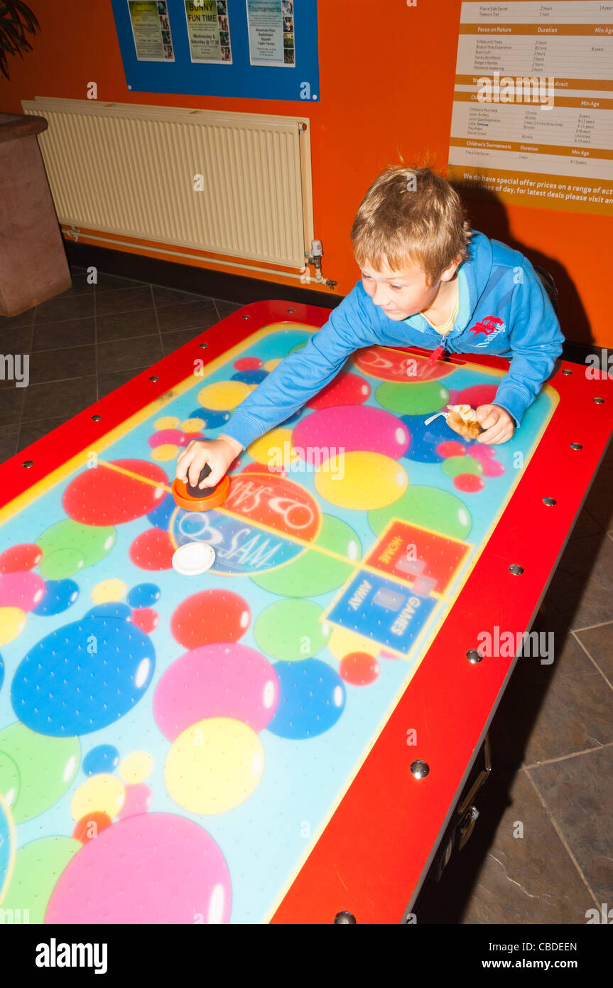 An eight year old boy playing air soccer at Center Parcs in Elveden near Thetford , England , Britain , Uk Stock Photo