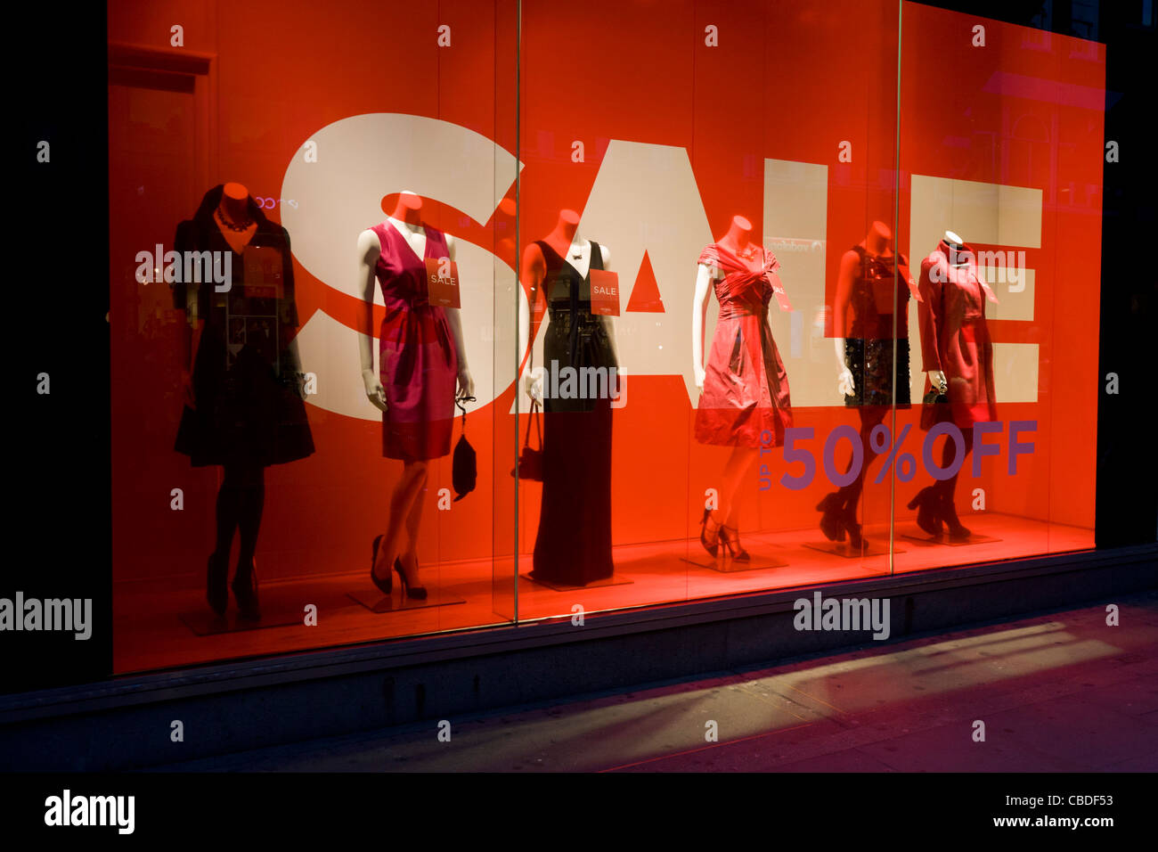 Sale sign and mannequins in a window of clothing emporium Hobbs in