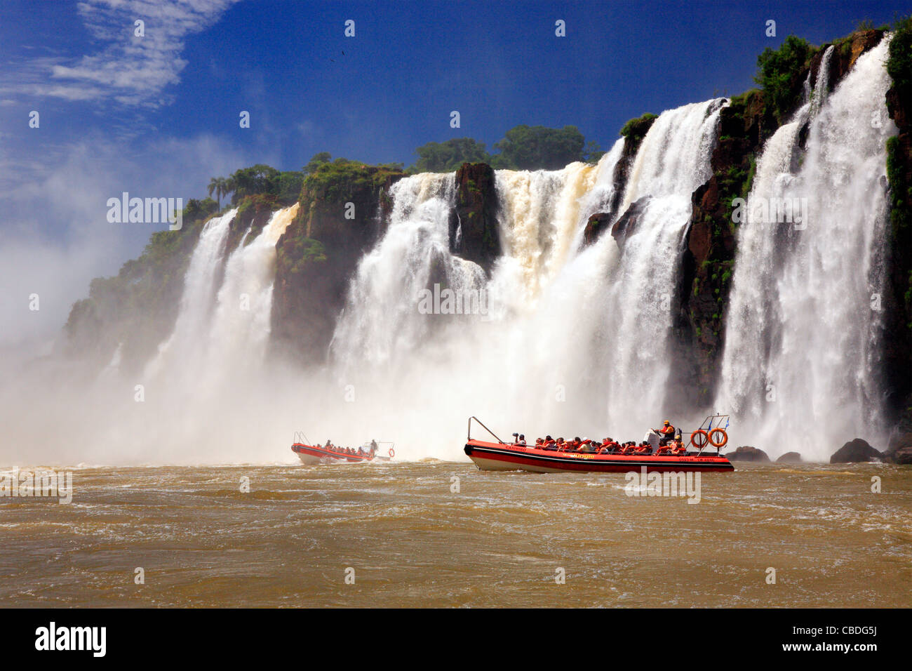 boats with tourists along along Iguazu river. Placed in the border of Argentina, and Brasil. Stock Photo