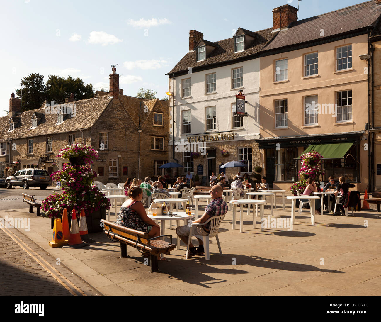 People sitting outside with the Star Inn behind Woodstock Oxfordshire UK Stock Photo