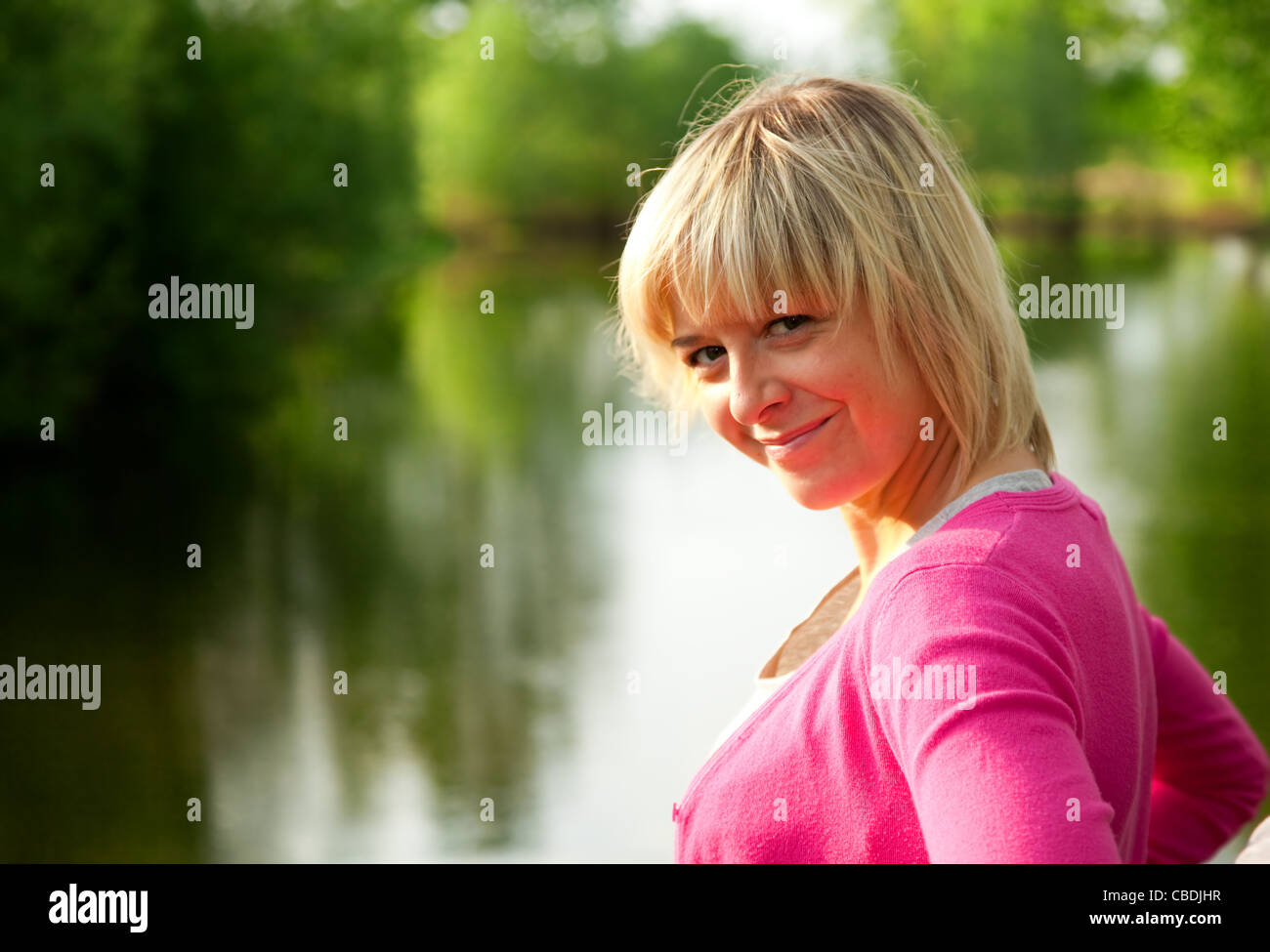 Happy woman smiling outdoors in hi-res stock photography and images - Alamy