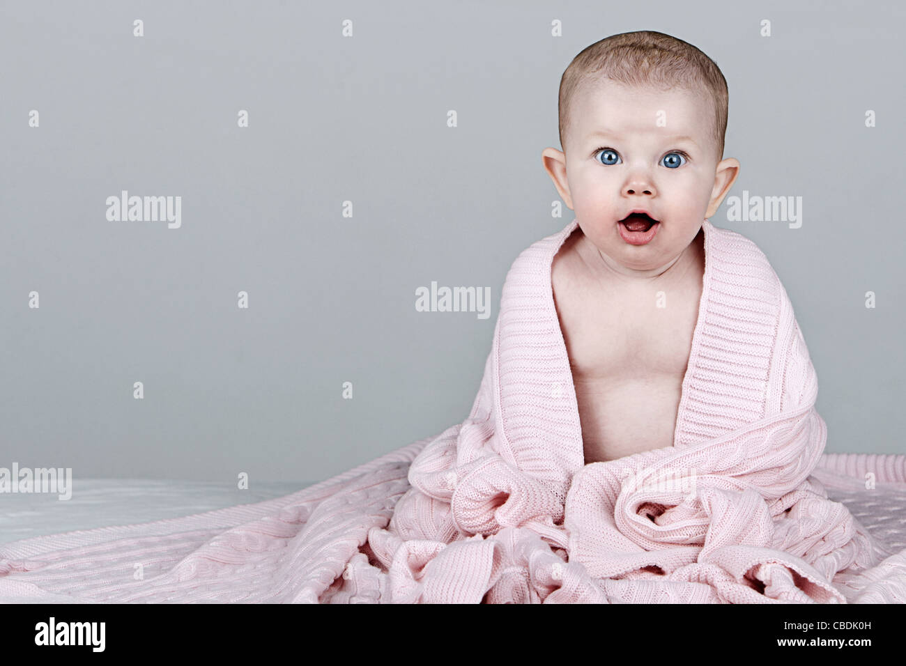 Beautiful Baby in Pink Blanet Stock Photo