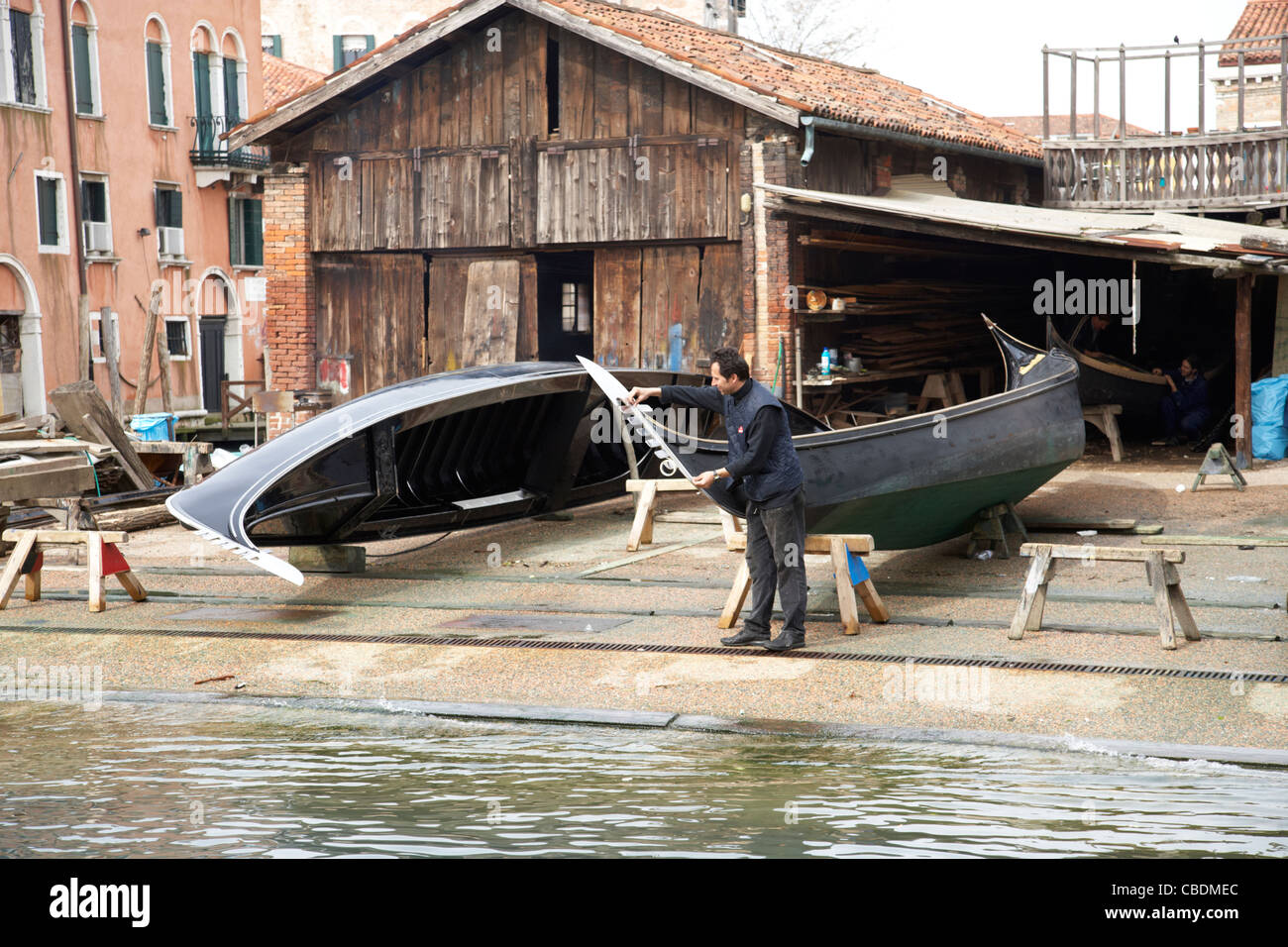 Gondola boat builder on canal in Venice Stock Photo