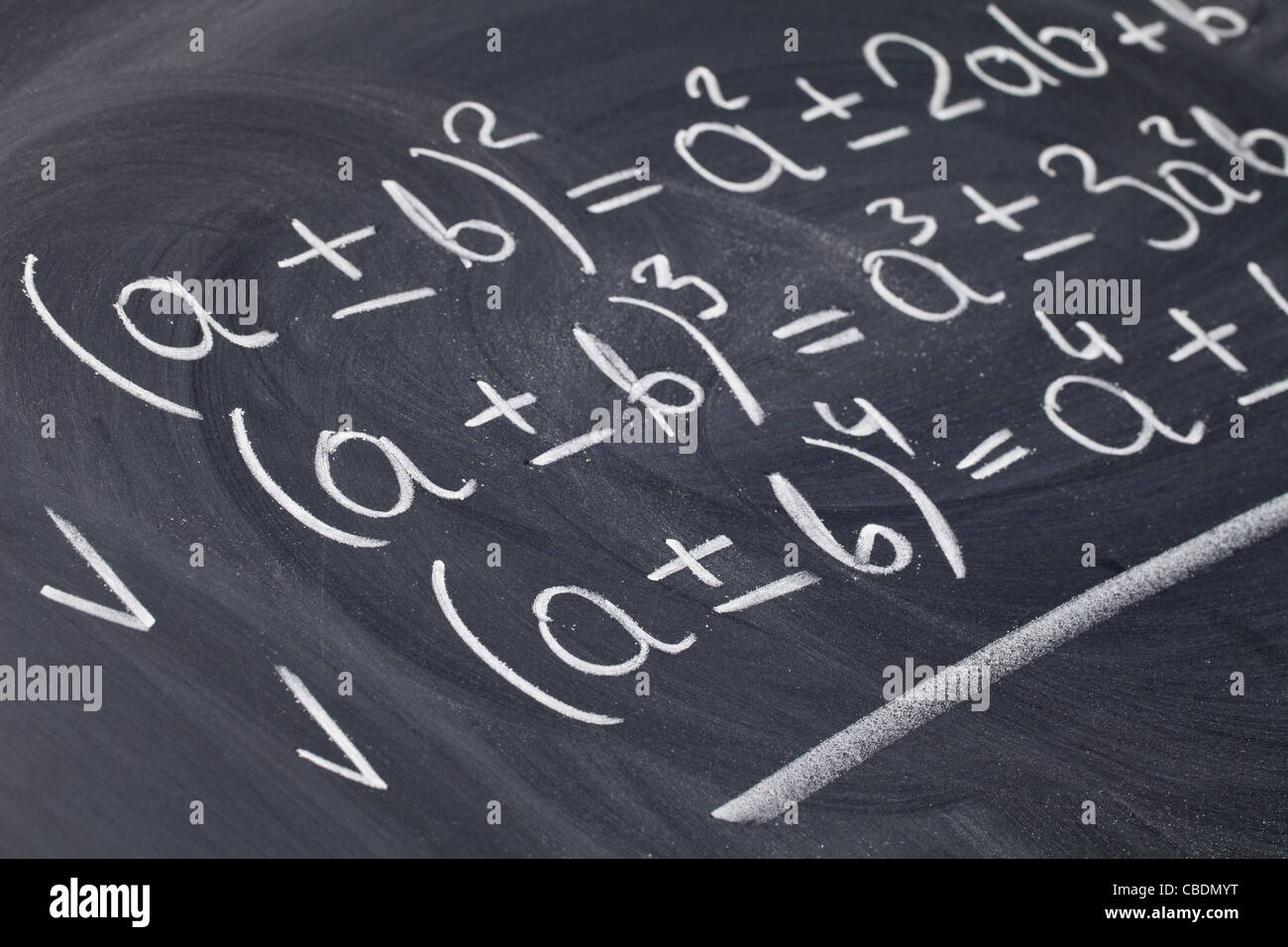 mathematical education concept - algebra equations handwritten with white chalk on blackboard Stock Photo