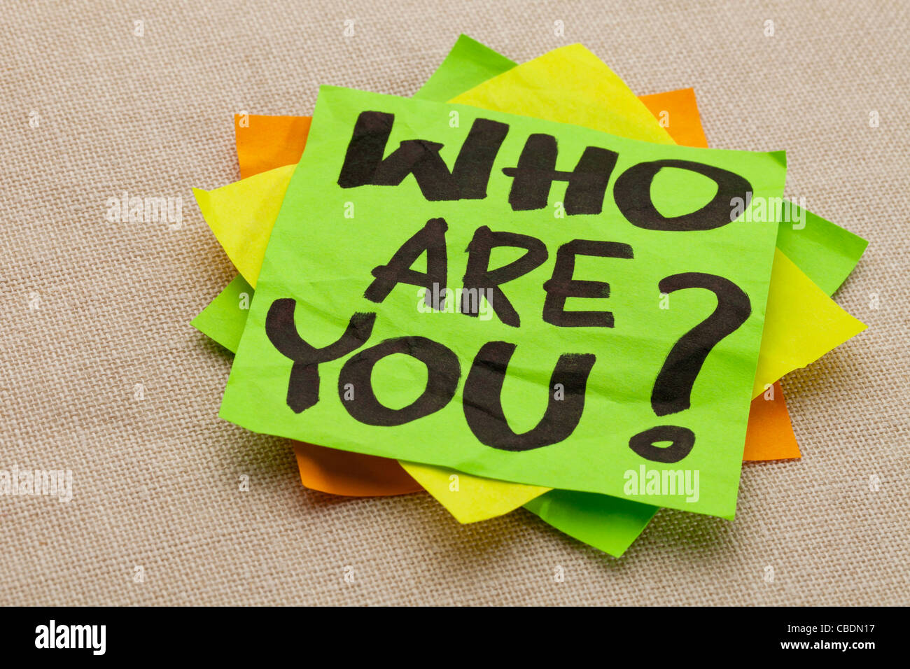 Who are you question - handwriting on a green sticky note Stock Photo