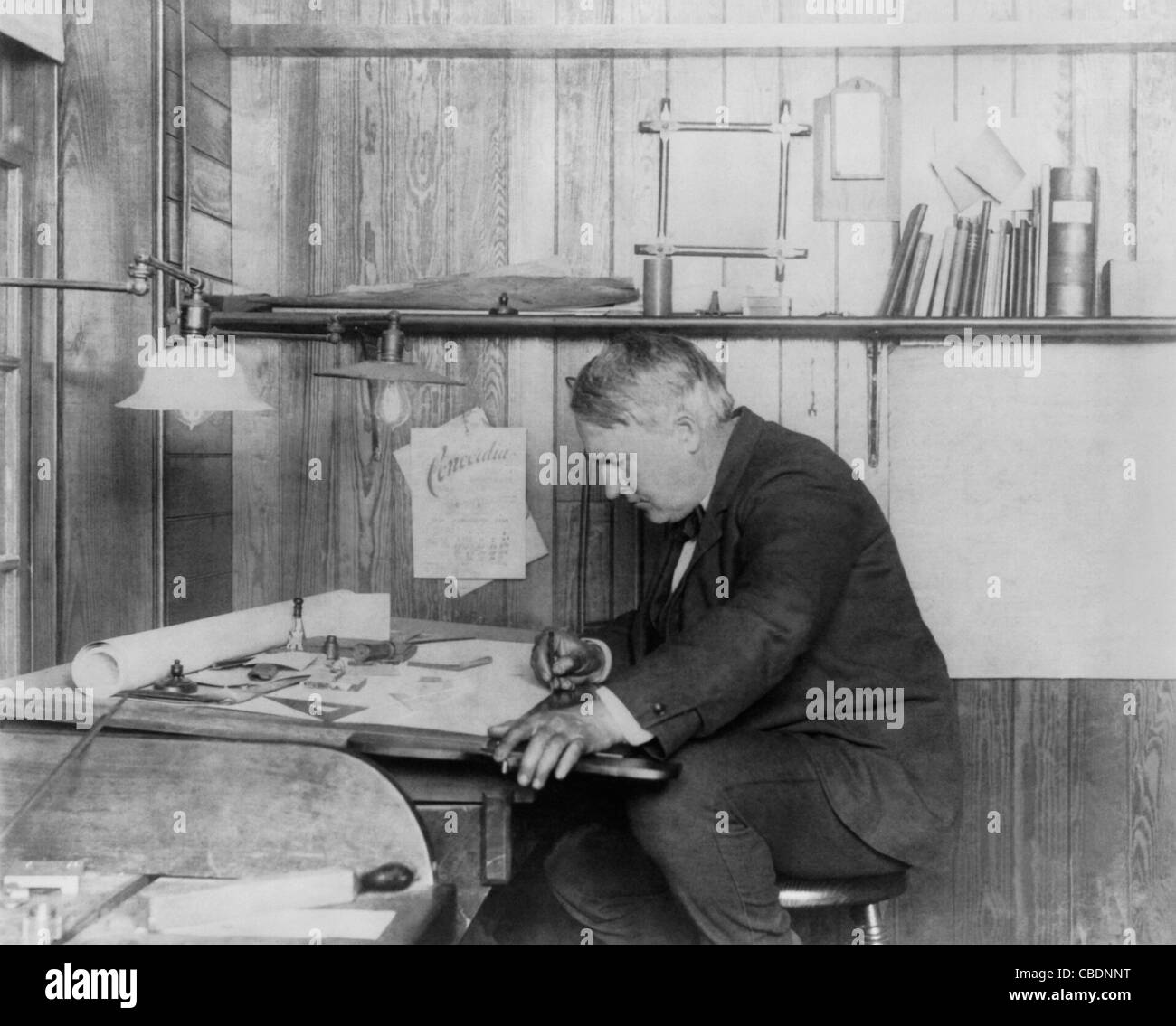 Vintage photo of American inventor and businessman Thomas Alva Edison (1847 – 1931). Edison is pictured working at a desk circa 1905. Stock Photo
