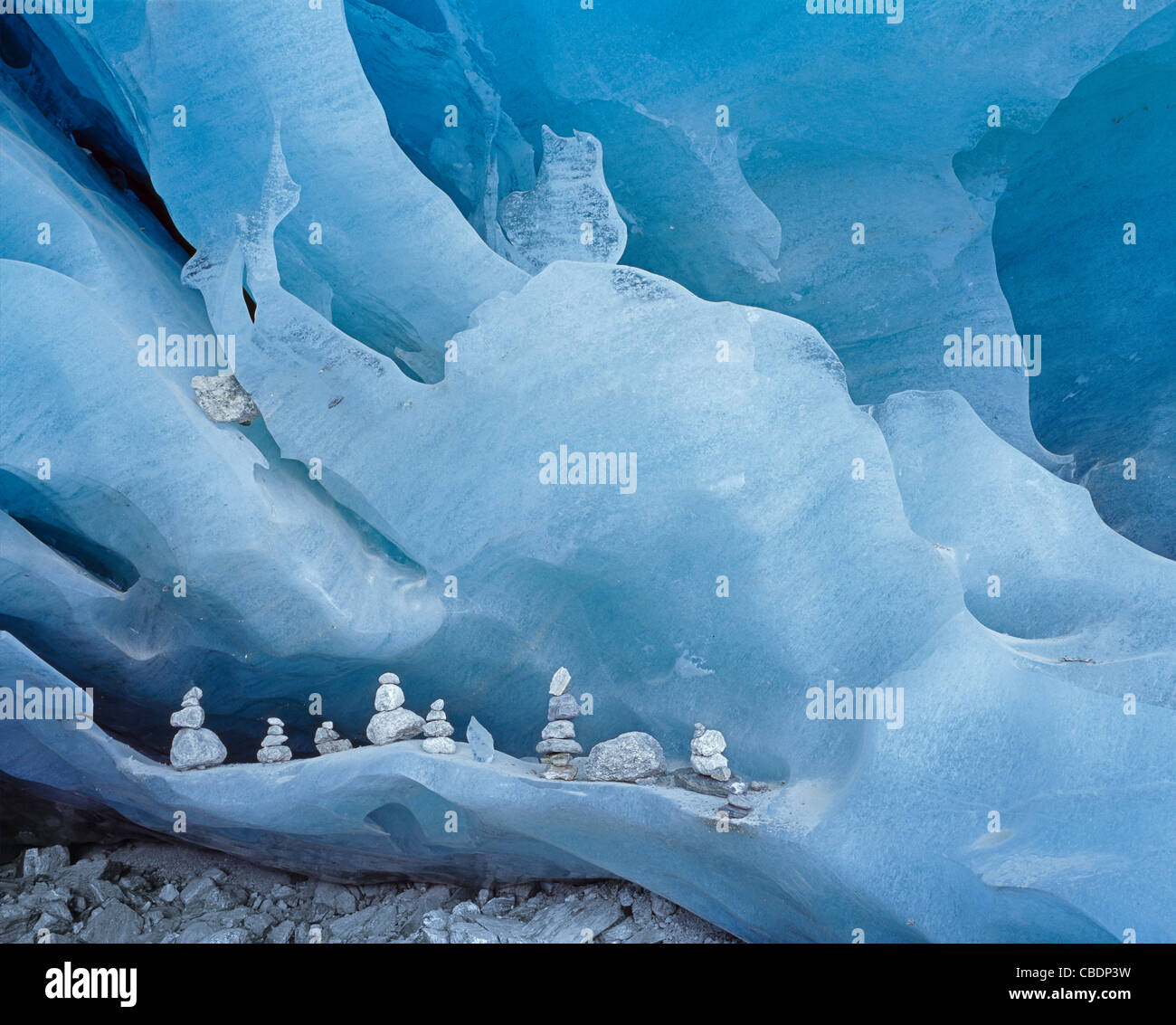 small rock cairns in the beautiful blue ice cave of the Glacier de Zinal in Valais Wallis Switzerland Stock Photo