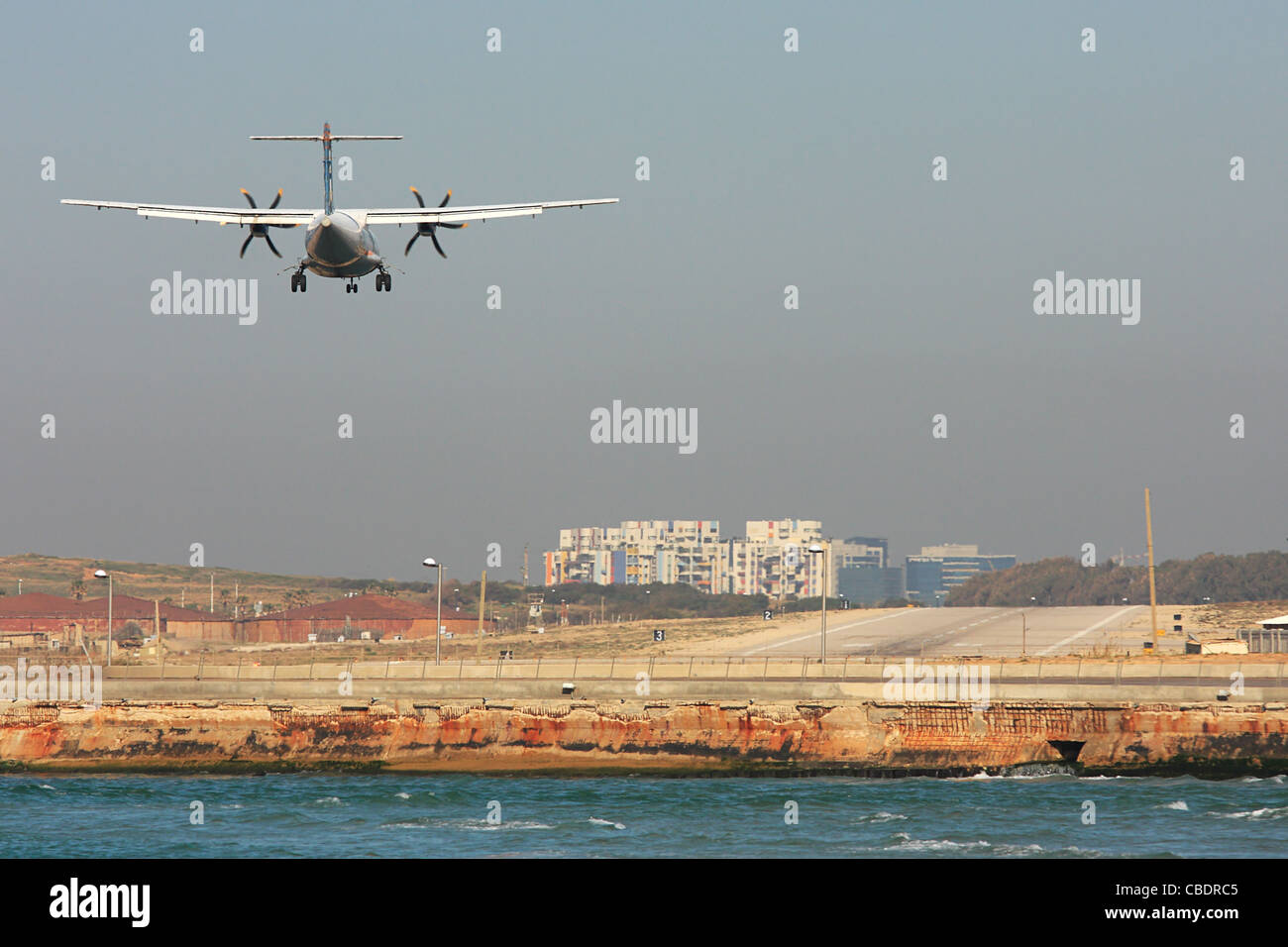 Passenger airplane few moments before landing on runway at the airport of Sde Dov in Tel Aviv, Israel. Stock Photo