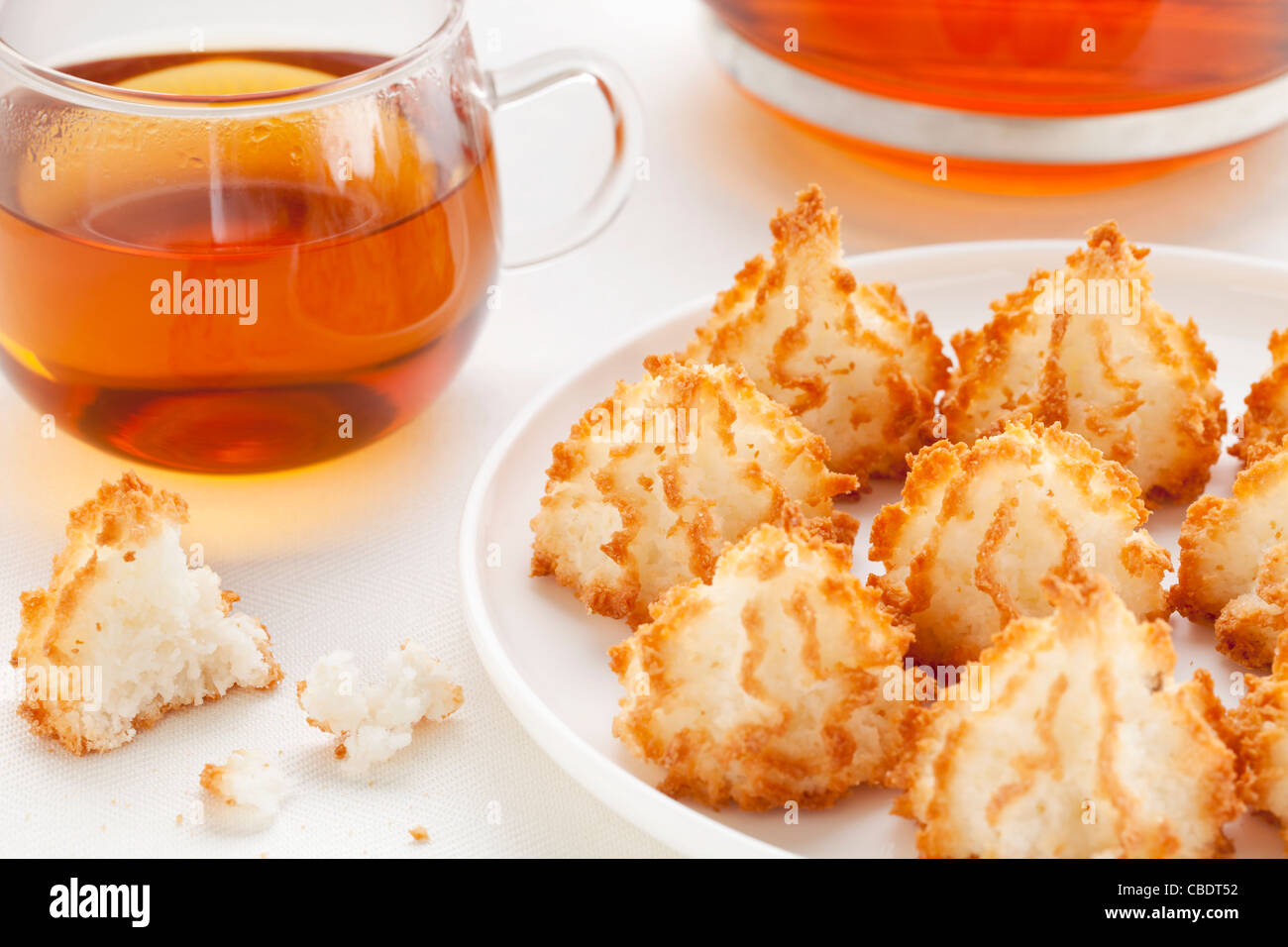 plate of coconut macaroon cookies and cup of tea Stock Photo