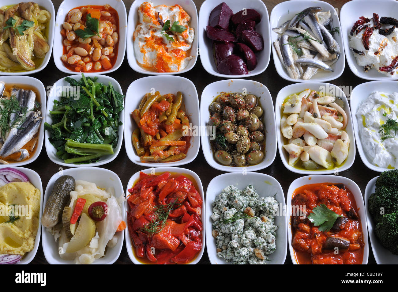 different kinds of Turkish and Greek snacks on the dinner table with traditional drink akı and ouzo Stock Photo