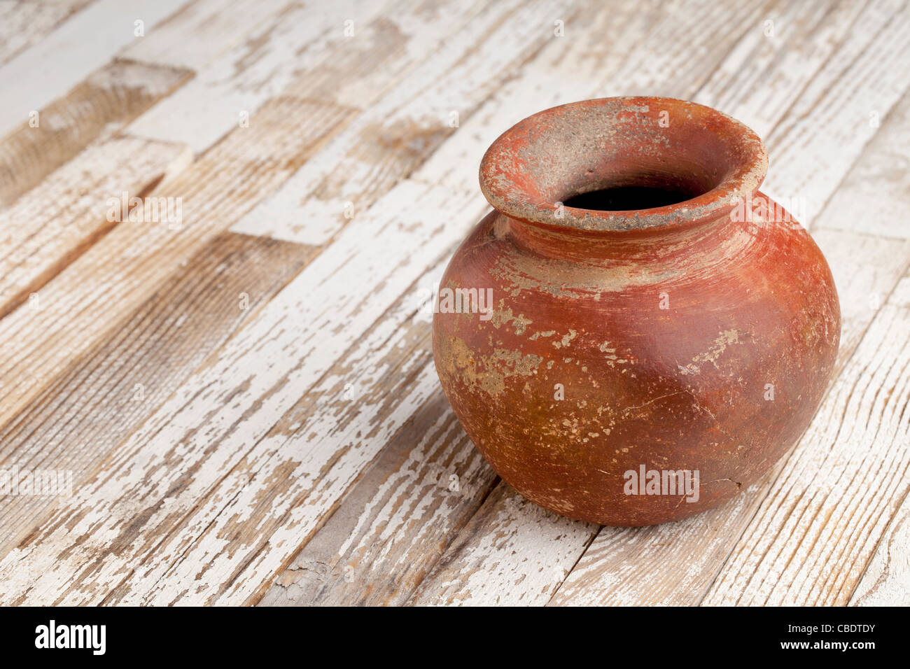 small red and brown clay plant pot (mass produced planter) with rough