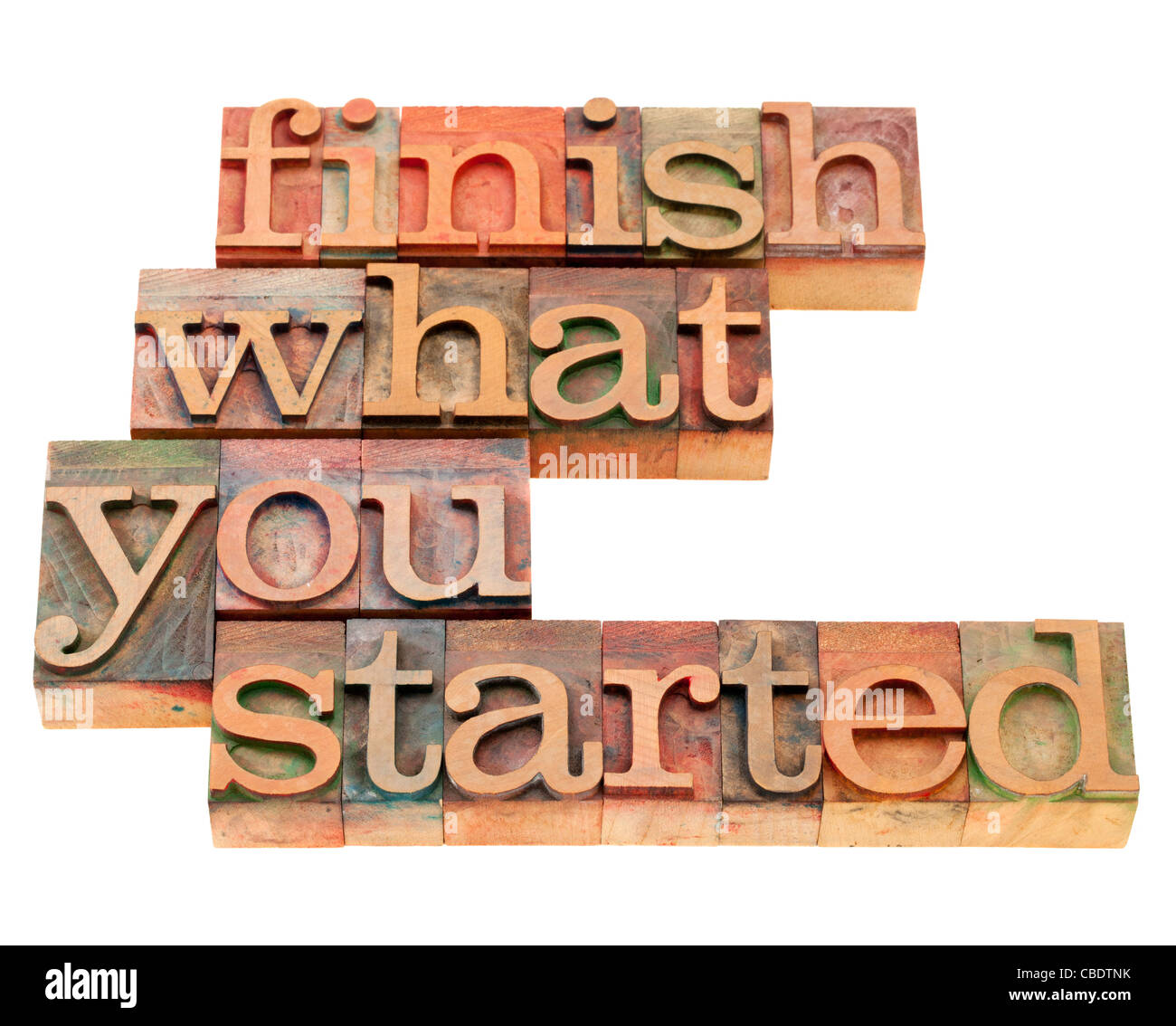 finish what you started - motivational slogan in vintage wood letterpress printing blocks, isolated on white Stock Photo