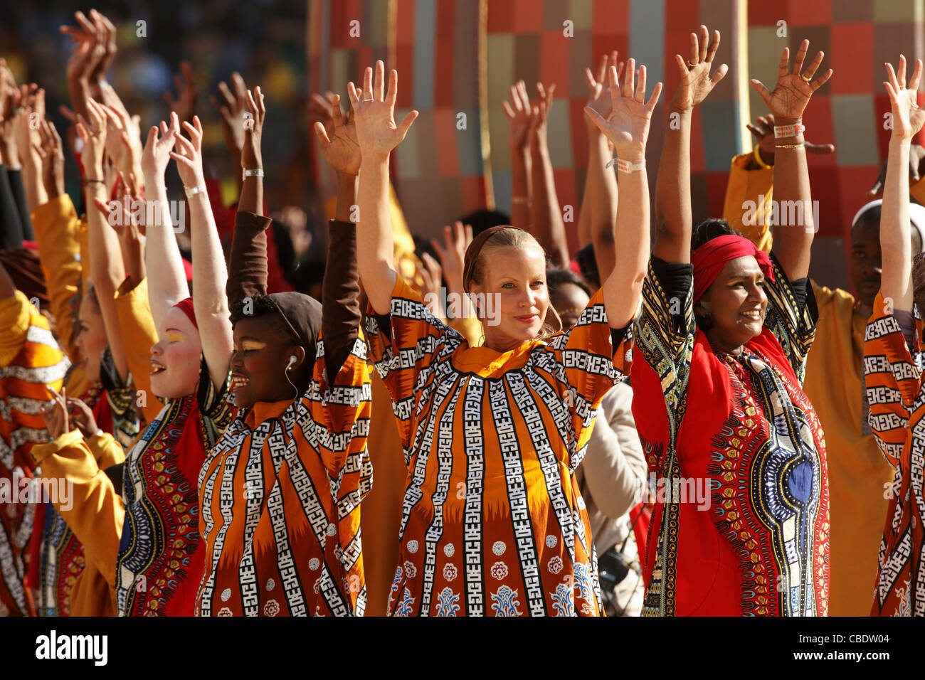 Performers raise their arms during the opening ceremony of the 2010 FIFA World Cup soccer tournament at Soccer City Stadium. Stock Photo