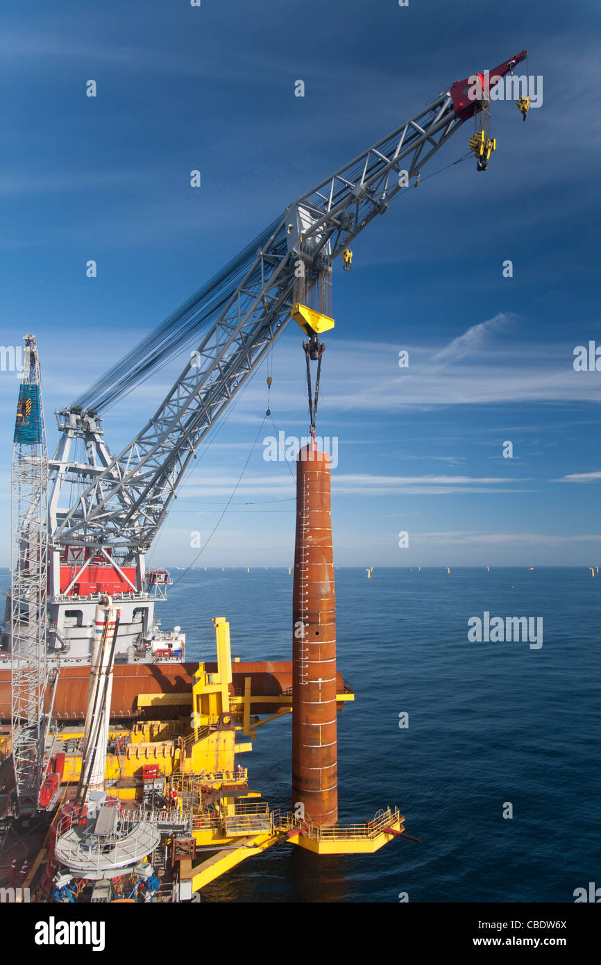 Wind Turbine foundation installation by a large crane vessel Stock Photo