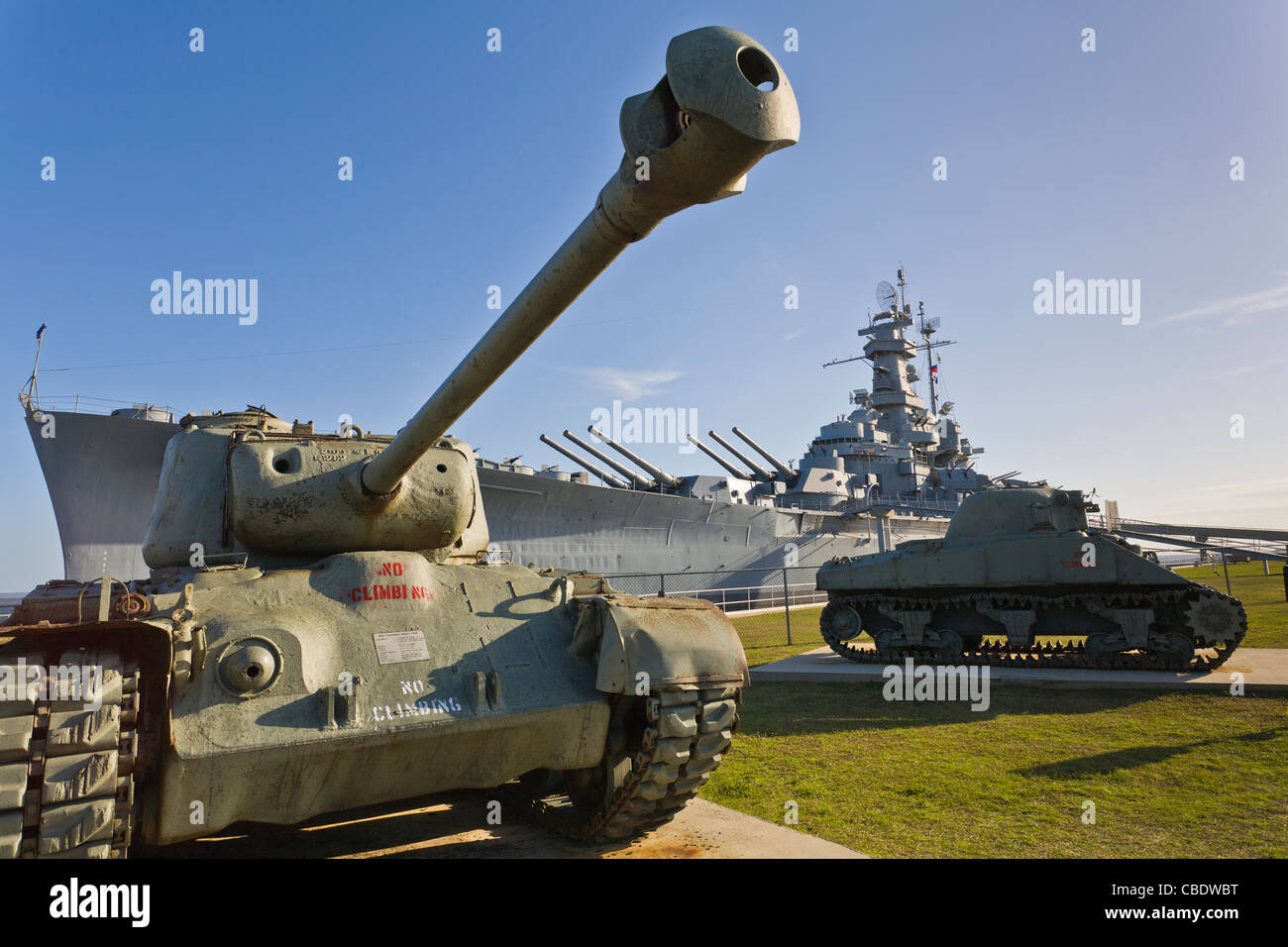 Tanks in foreground of Battleship USS Alabama Memorial park tourist