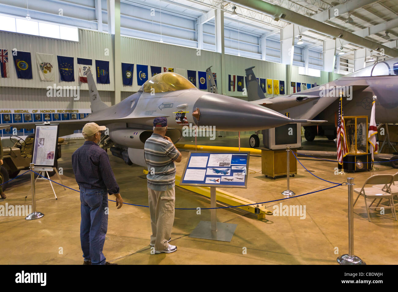 Two men looking at planes in the Aircraft museum at the USS Alabama Battleship Park in Mobile Alabama Stock Photo