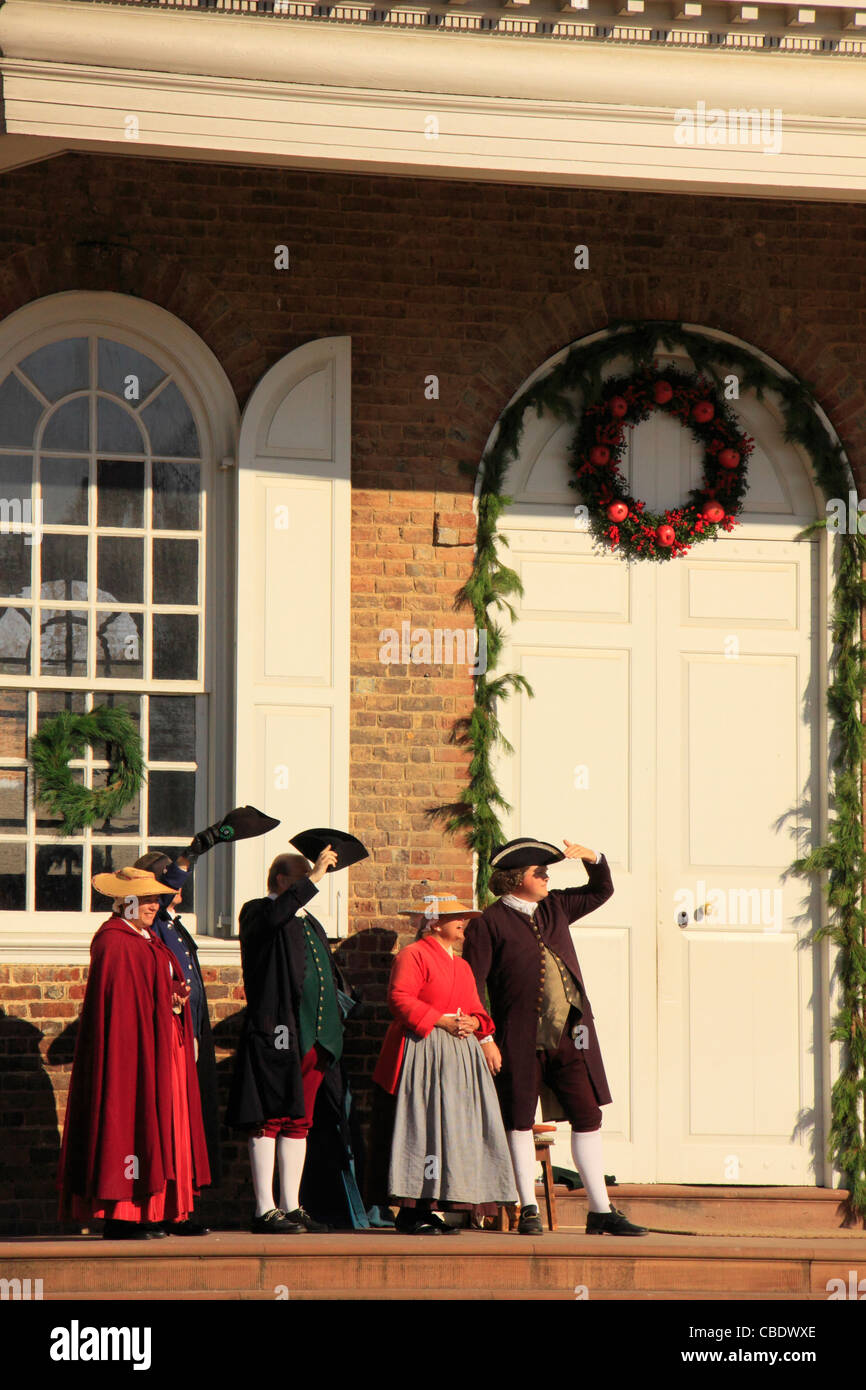Men and Women with Christmas Decorations in Front of Courthouse