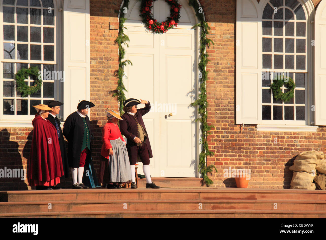 Men and Women with Christmas Decorations in Front of Courthouse