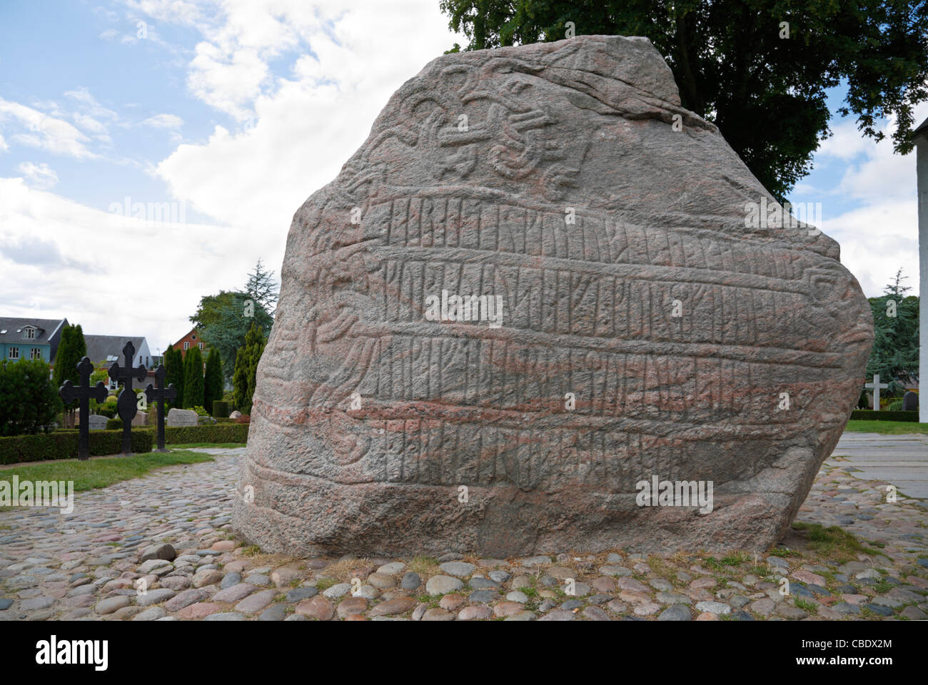 Runic inscription on the large Jelling rune stone from the tenth century raised by King Harald Bluetooth in Jelling. Figure of Jesus on other side Stock Photo