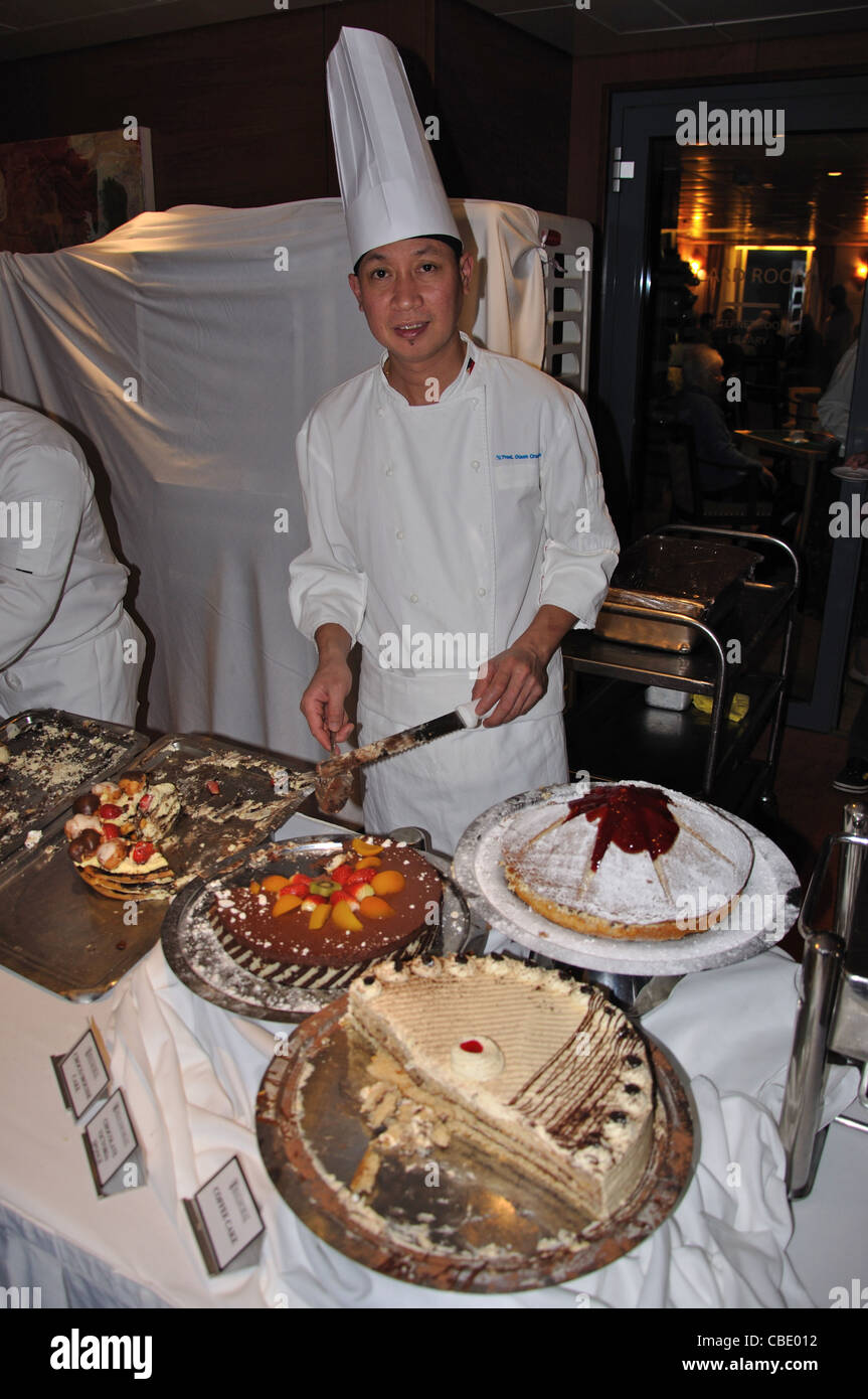 Chef serving pastries to passengers onboard Fred Olsen 'M S Balmoral' cruise ship, North Sea, Europe Stock Photo