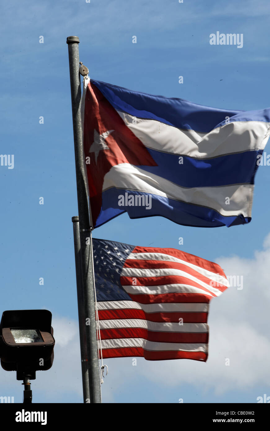 US and Cuban flags fly at the Bay of Pigs memorial in Miami Stock Photo
