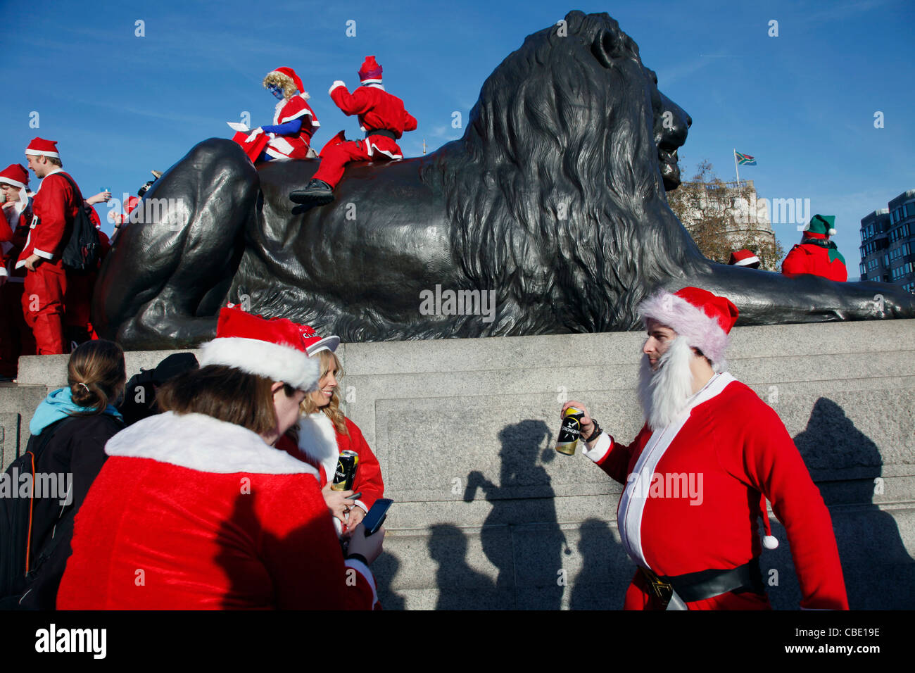 Santas hold a flashmob gathering in Trafalgar Sq., as London warms up for Christmas. England, UK Stock Photo