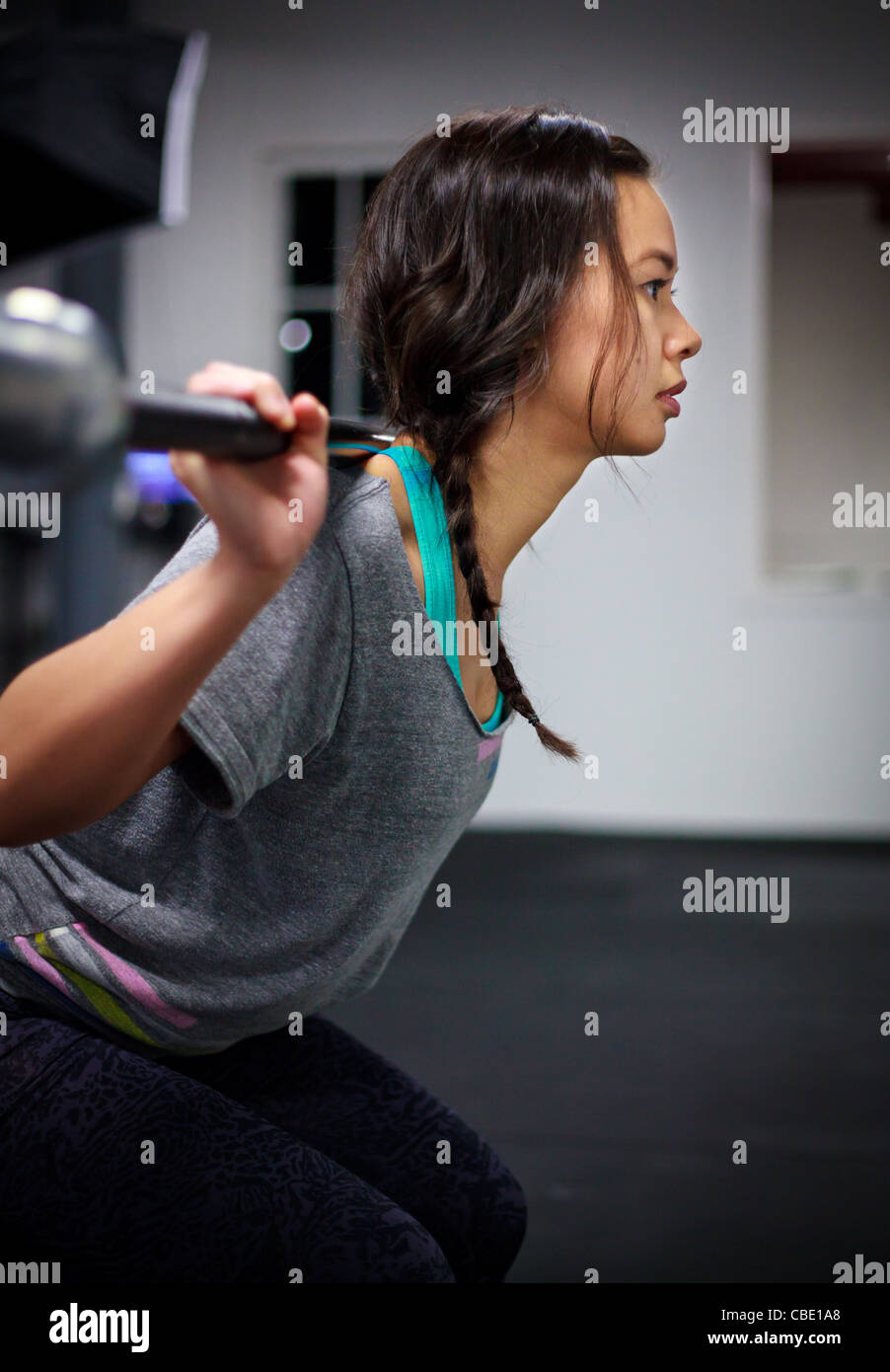 Asian Chinese Female Barbell Workout Exercise At Gym Stock Photo