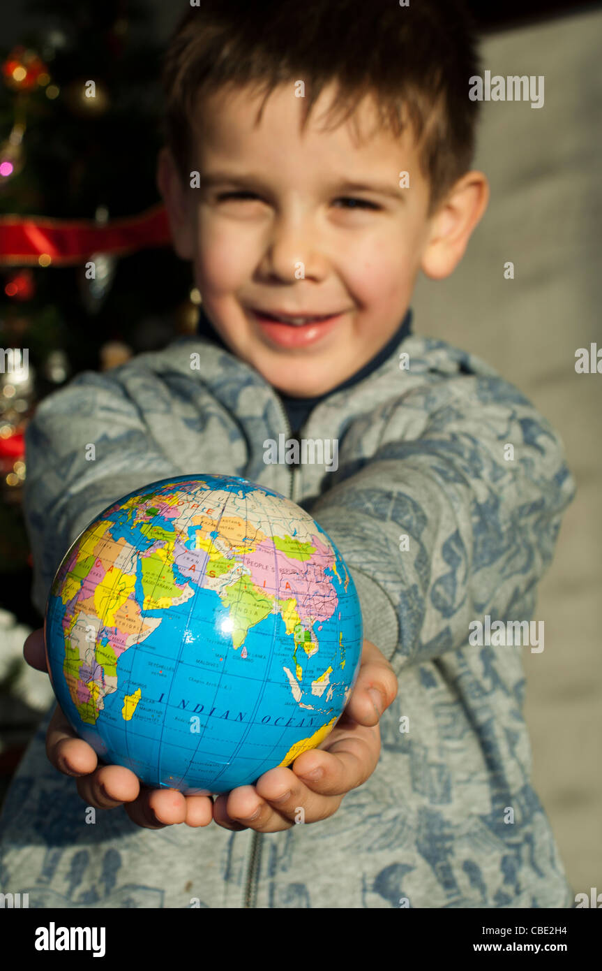 Child who give as gift the world on Christmas. Stock Photo
