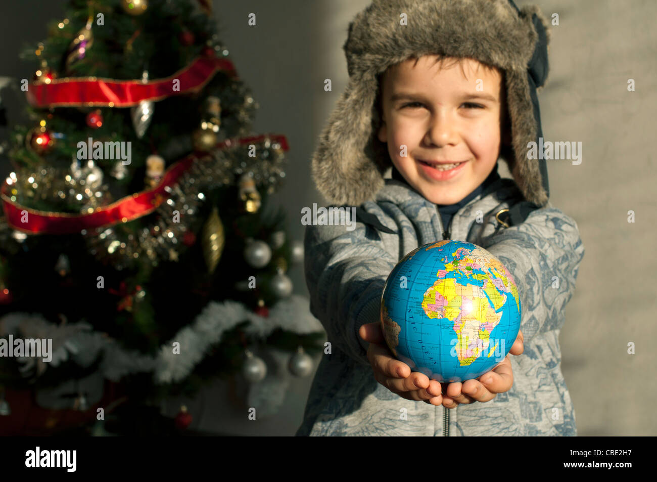 Child who give as gift the world on Christmas. Stock Photo